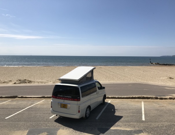Campervan with poptop at bournemouth beach